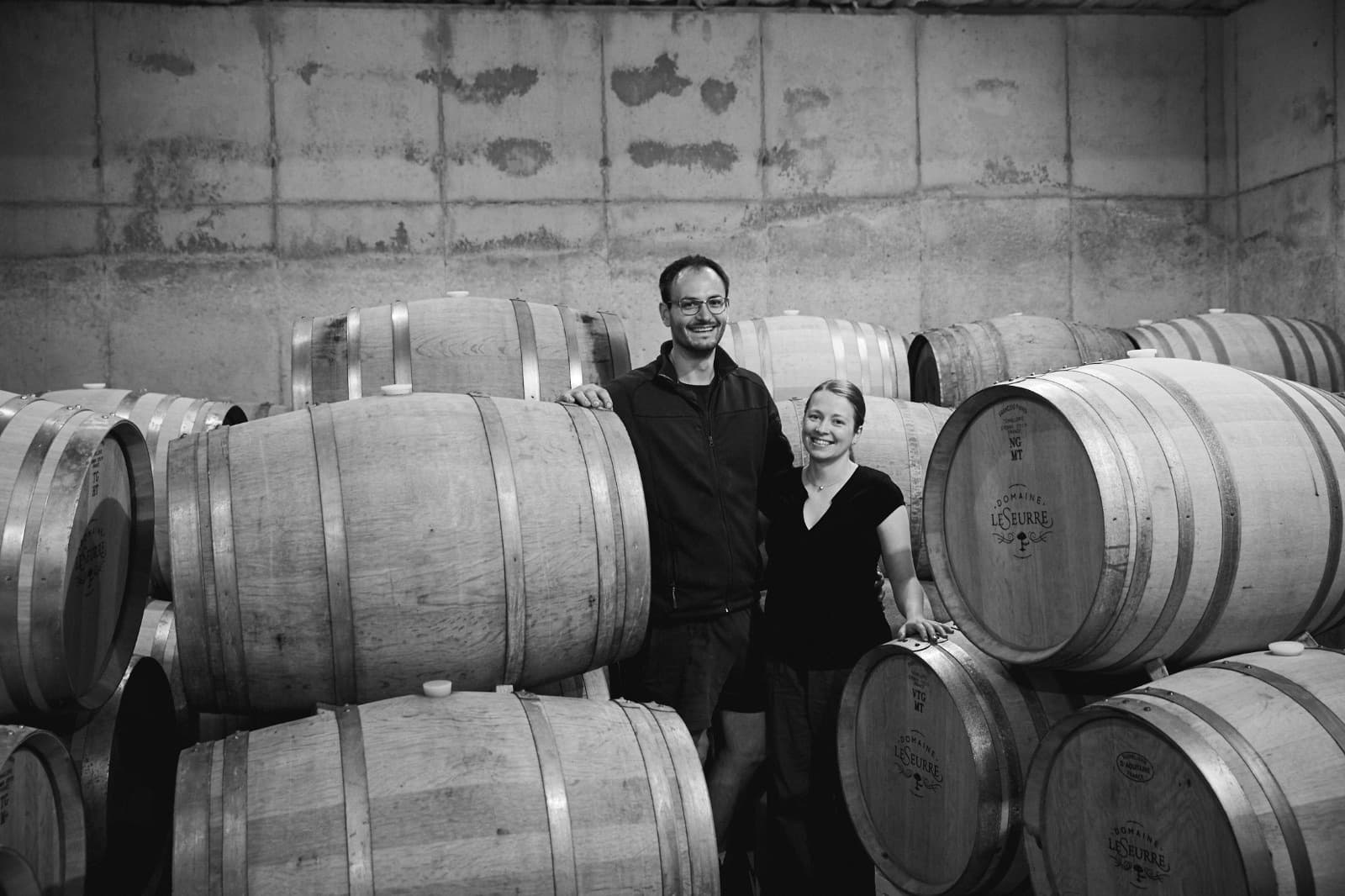 Céline & Sébastien LeSeurre among the Domaine LeSeurre French oak barrels in the cellar.