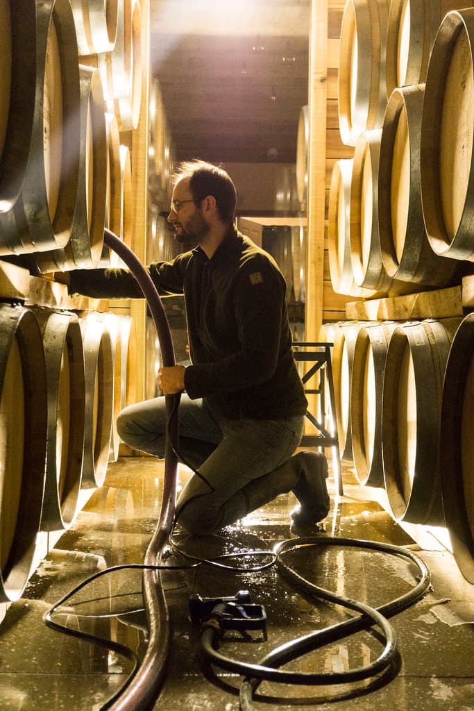 Sébastien LeSeurre among the French oak barrels in the cellar.
